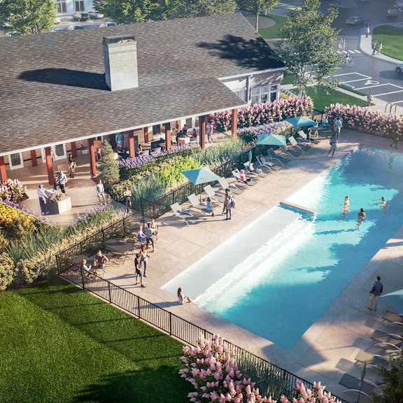 an aerial view of a pool and a building with people in it