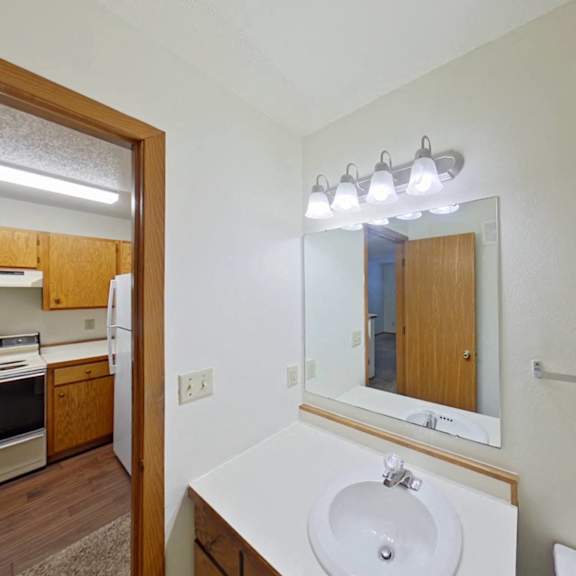 Thumbnail 2 of 10 A bathroom with a sink, mirror, and light fixture.