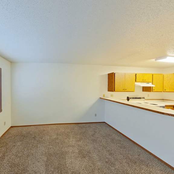 Thumbnail 6 of 10 A room with a window and a carpeted floor.