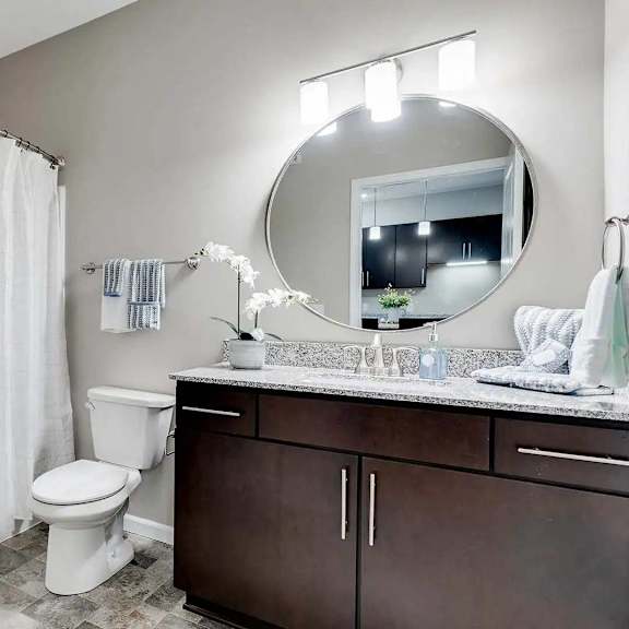 Thumbnail 9 of 10 a bathroom with a white toilet and a sink. Circle Pines, MN Lexington Lofts