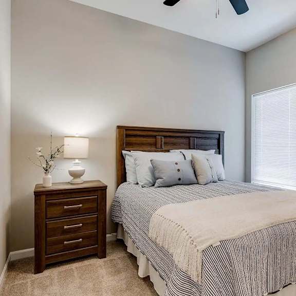 Thumbnail 6 of 10 a bedroom with a bed and a closet. Circle Pines, MN Lexington Lofts