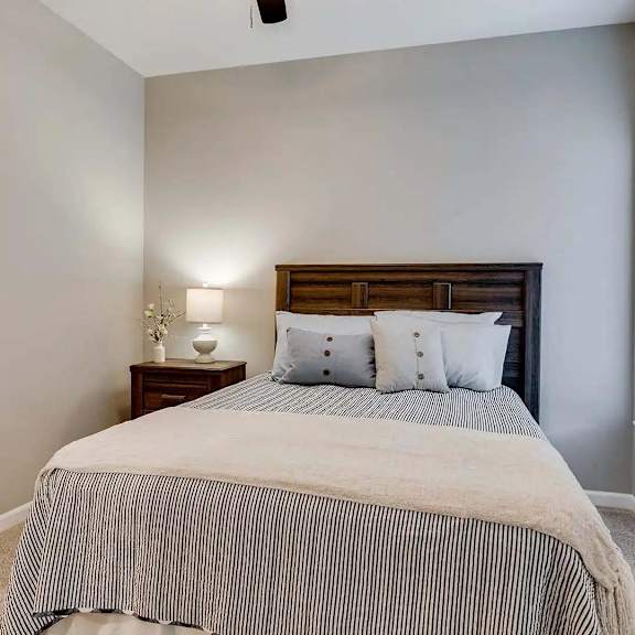 Thumbnail 7 of 10 a bedroom with a bed and a window. Circle Pines, MN Lexington Lofts