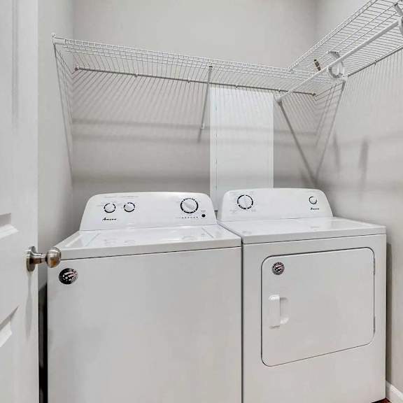 Thumbnail 10 of 10 a washer and dryer in a laundry room with white walls. Circle Pines, MN Lexington Lofts