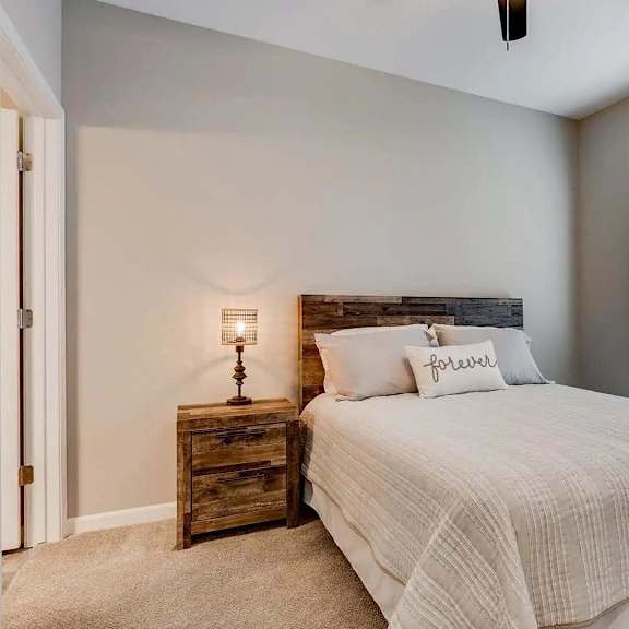 Thumbnail 8 of 12 a bedroom with a bed and a window.  Circle Pines, MN Lexington Lofts