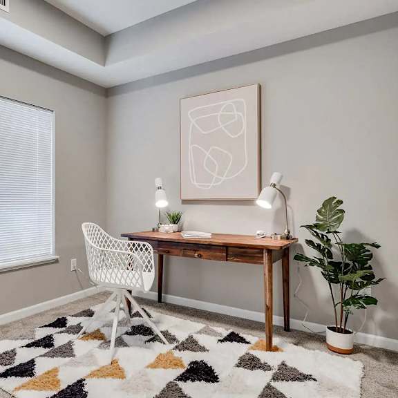 Thumbnail 11 of 11 a home office with a large window and a desk with a chair. Circle Pines, MN Lexington Lofts