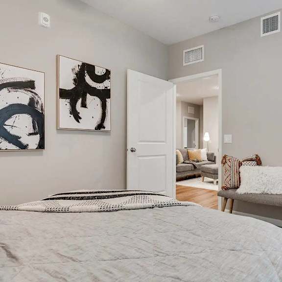 Thumbnail 7 of 11 a bedroom with a bed and a mirror.. Circle Pines, MN Lexington Lofts