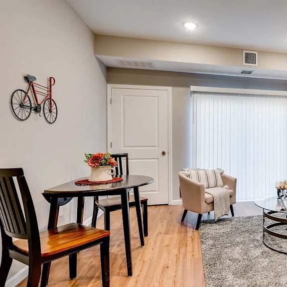 Thumbnail 5 of 7 a living room with a couch and a table. Circle Pines, MN Lexington Lofts