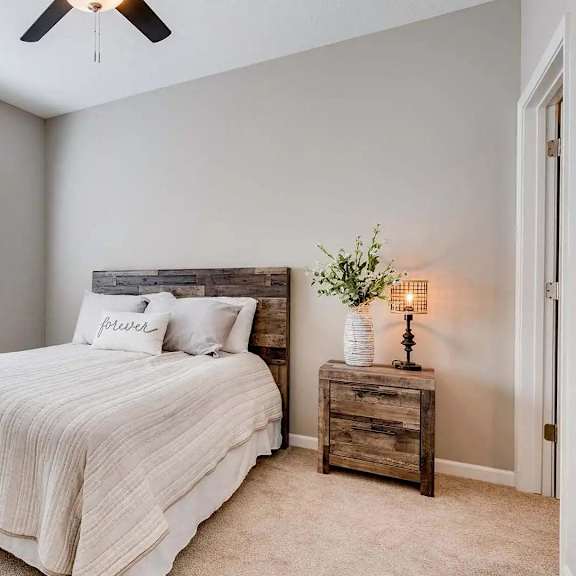 Thumbnail 4 of 6 a bedroom with a bed and a window. Circle Pines, MN Lexington Lofts