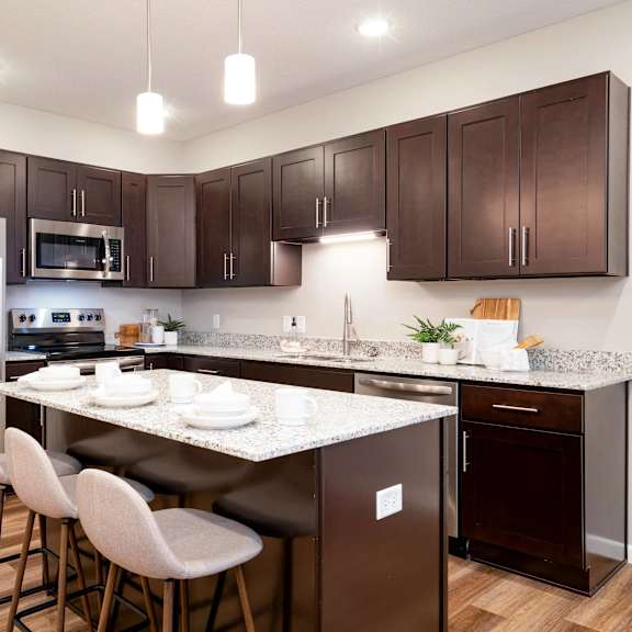 Thumbnail 2 of 6 full kitchen with stainless steel appliances and granite counter tops. Circle Pines, MN Lexington Lofts