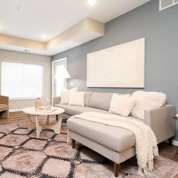 Thumbnail 4 of 6 a living room with a couch and chairs. Circle Pines, MN Lexington Lofts