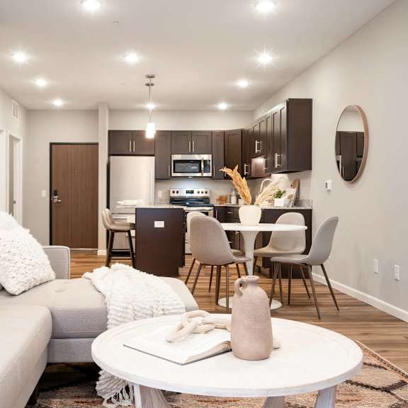 Thumbnail 3 of 6 a living room with a couch and a table. Circle Pines, MN Lexington Lofts