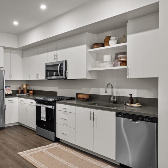 Thumbnail 5 of 8 a kitchen with white cabinets and stainless steel appliancesat Westbury Apartments, Rancho Cucamonga, 91739