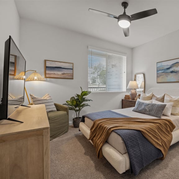 Thumbnail 6 of 8 a bedroom with a bed and a ceiling fanat Westbury Apartments, California