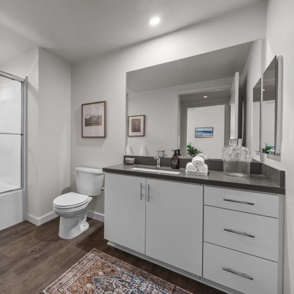Thumbnail 7 of 8 a bathroom with a shower toilet and sink and a mirrorat Westbury Apartments, Rancho Cucamonga, California