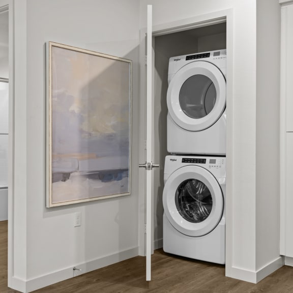 Thumbnail 8 of 8 a white washer and dryer in a closet with a doorat Westbury Apartments, Rancho Cucamonga, California