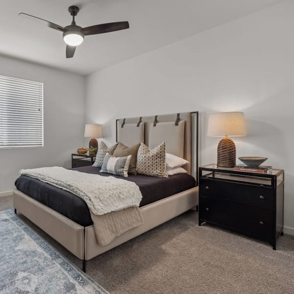 Thumbnail 6 of 8 a bedroom with a bed and a ceiling fanat Westbury Apartments, Rancho Cucamonga, CA, 91739