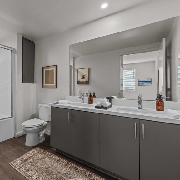 Thumbnail 7 of 8 a bathroom with a shower toilet and sink and a mirrorat Westbury Apartments, Rancho Cucamonga, CA, 91739