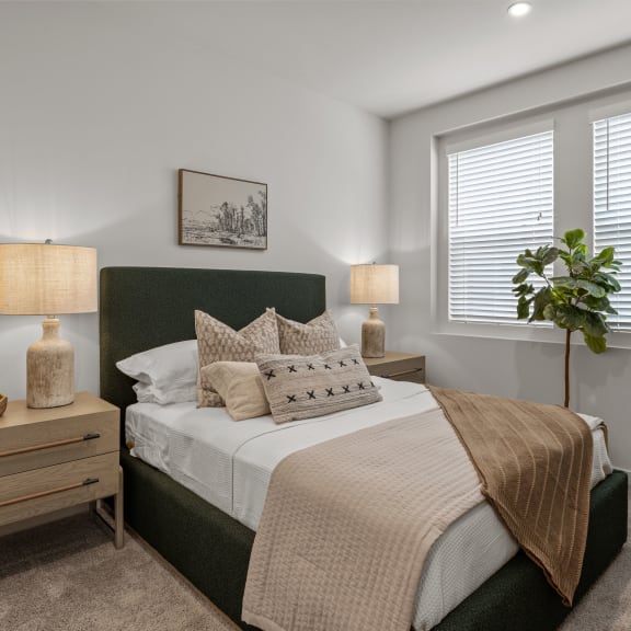 Thumbnail 5 of 8 an empty bedroom with a bed and two windowsat Westbury Apartments, California