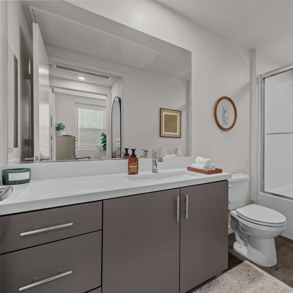 Thumbnail 8 of 8 a bathroom with a shower and a sink and a toiletat Westbury Apartments, California