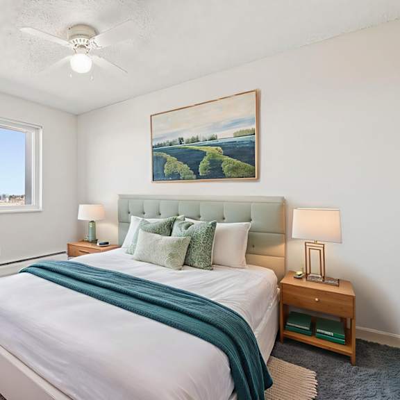a bedroom with a large bed and a painting on the wall.