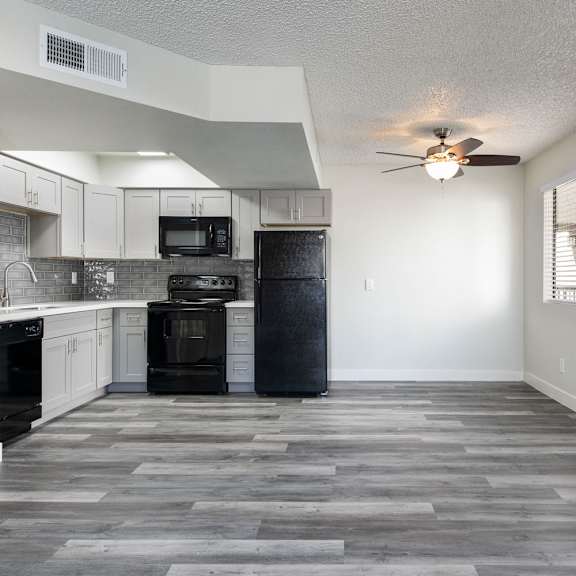 a kitchen with a black oven and microwave.