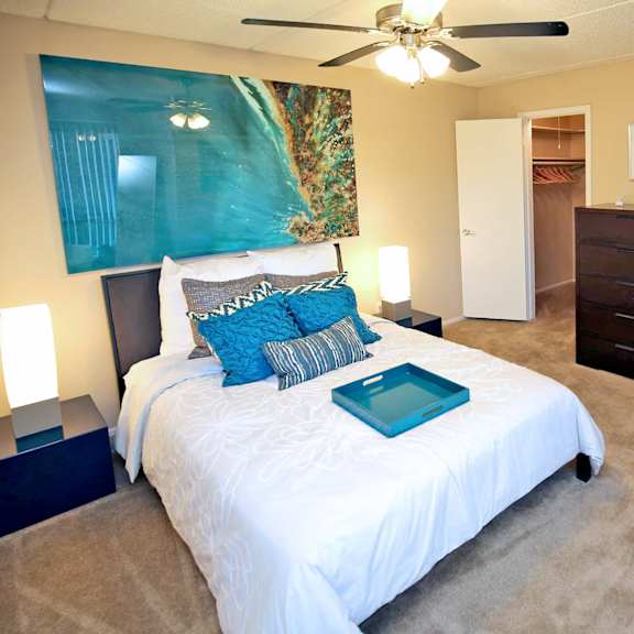 a bedroom with a bed and a ceiling fan