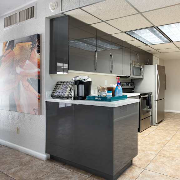 a kitchen with a counter and a refrigerator