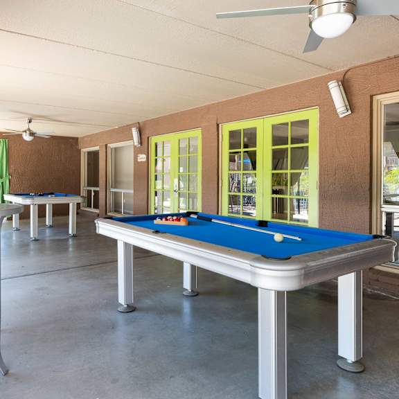 a game room with a pool table and a bar
