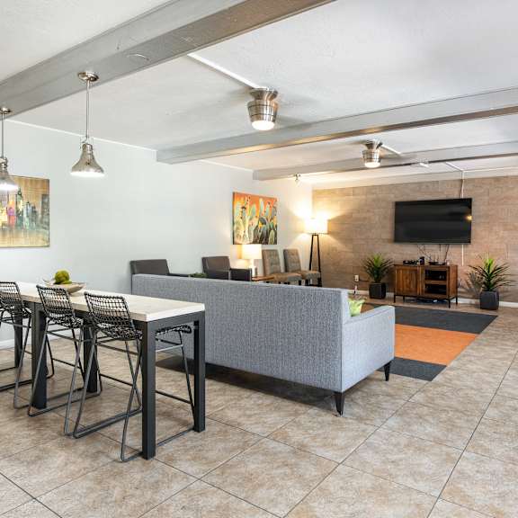 a living room with a couch and a table with chairs