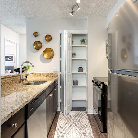a kitchen with stainless steel appliances and granite counter tops