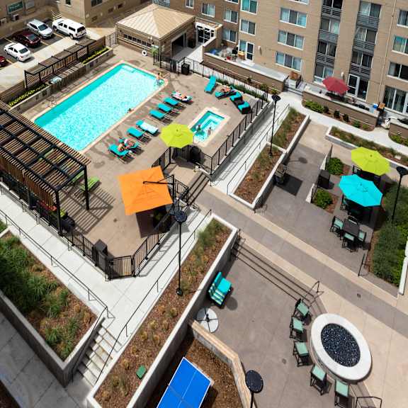 an overhead view of a swimming pool in the middle of an apartment building