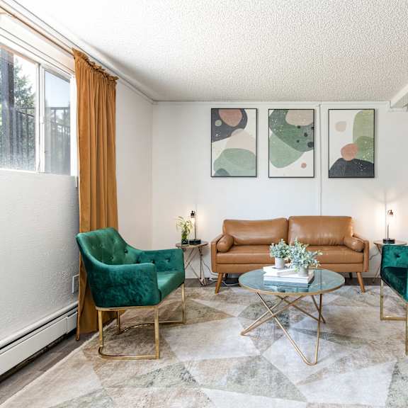a living room with two green chairs and a brown couch