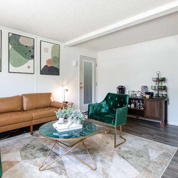 a living room with green chairs and a brown couch