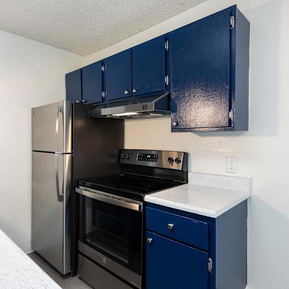 kitchen with navy cabinets and a black refrigerator