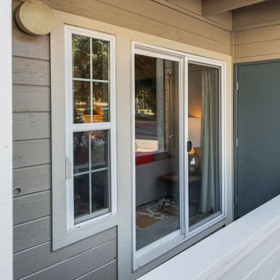 the front of the house has three windows and a door