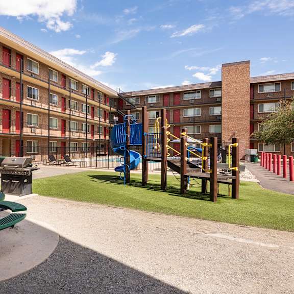 a playground in the courtyard of an apartment building