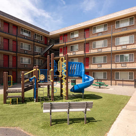 a playground in the middle of an apartment building