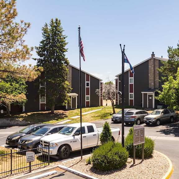 a parking lot in front of a building with cars parked