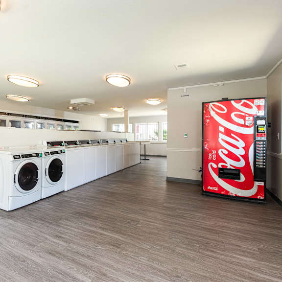 a laundry room with a coca cola coke machine
