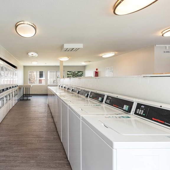 a laundry room filled with washers and dryer machines