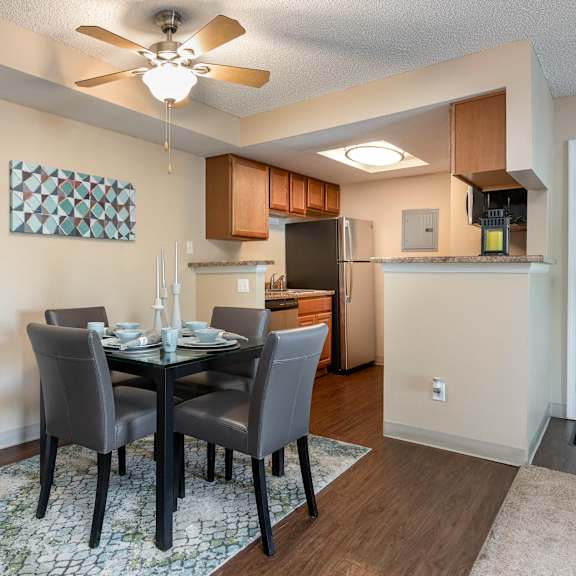 a dining room with a table and chairs and a kitchen
