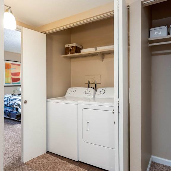 a laundry room with a washer and dryer and a closet
