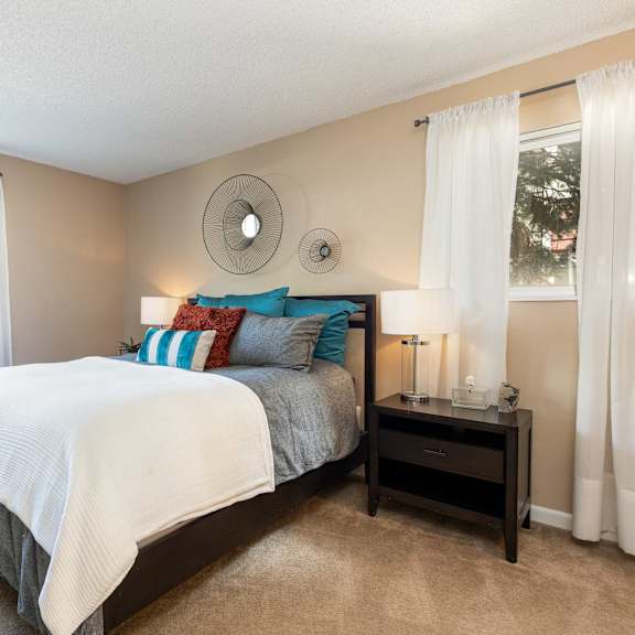 a bedroom with a bed and two windows