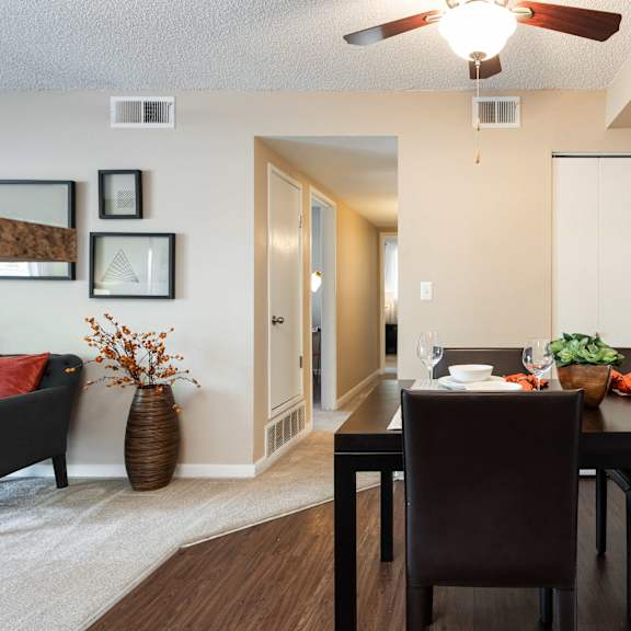 a dining room with a table and chairs and a mirror