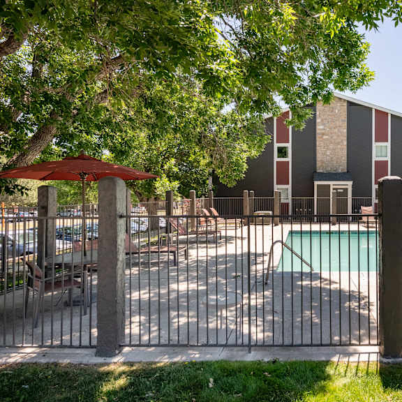 our apartments have a large pool and a patio with chairs