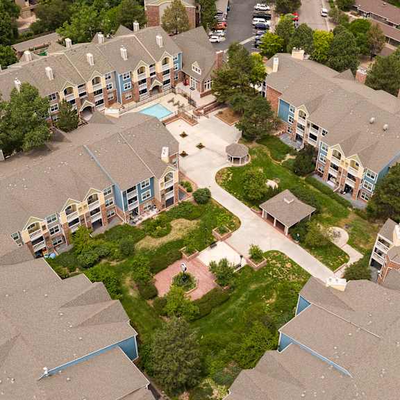 an aerial view of houses in a neighborhood with trees