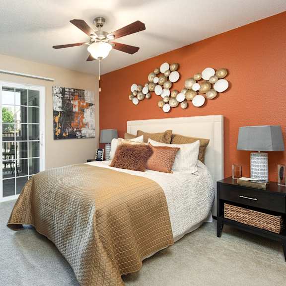 a bedroom with a bed and a ceiling fan
