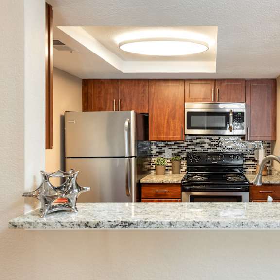 a kitchen with stainless steel appliances and granite counter tops