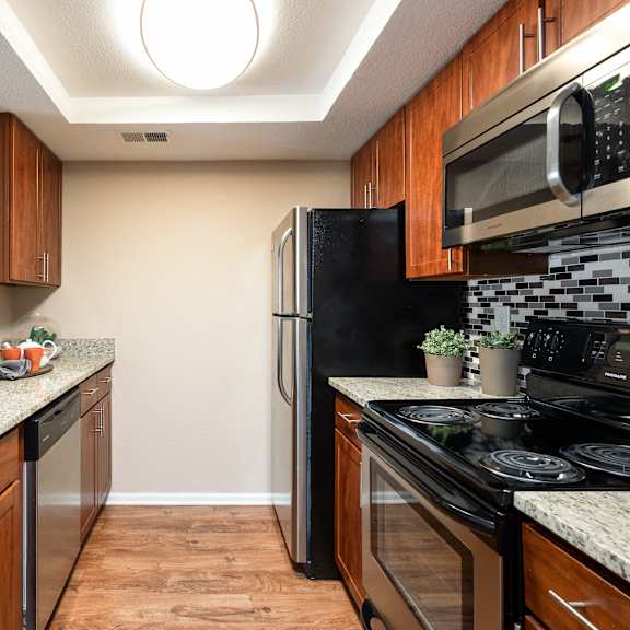 a kitchen with stainless steel appliances and granite counter tops