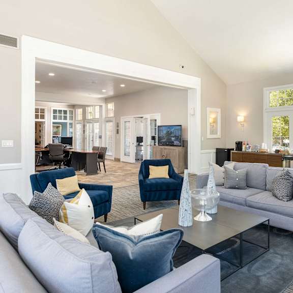 a living room with couches and chairs and a table